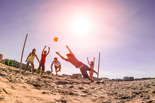 istock Multiracial friends playing soccer at beach 490633752