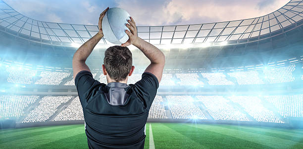 istock Composite image of back turned rugby player throwing a ball 490634018