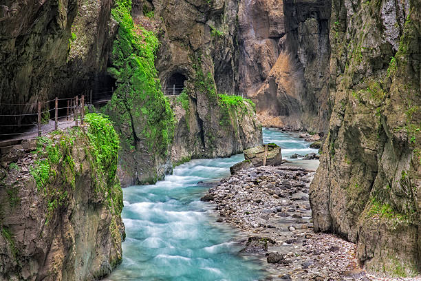 Fabulous gorge and mountain river Partnachklamm The Partnach Gorge is a deep gorge incised by a mountain stream, the Partnach is in the south German town of Garmisch-Partenkirchen. It was designated a natural monument in 1912. partnach gorge stock pictures, royalty-free photos & images