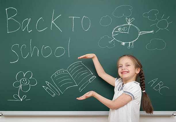istock girl drawing book on school board 490637806