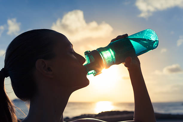 After workout Woman drinking water after her workout. quench your thirst pictures stock pictures, royalty-free photos & images