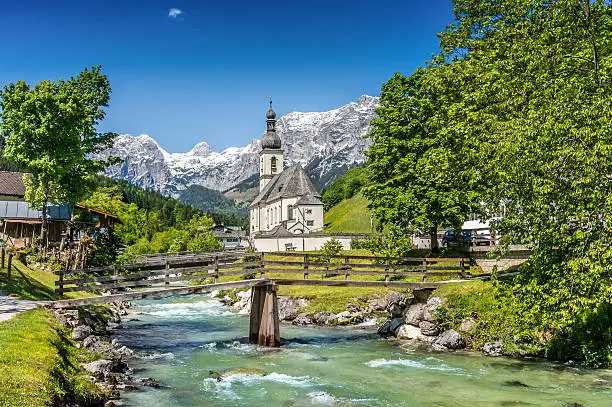 Scenic mountain landscape in the Bavarian Alps with famous Parish Church of St. Sebastian in the village of Ramsau in springtime, Nationalpark Berchtesgadener Land, Upper Bavaria, Germany.