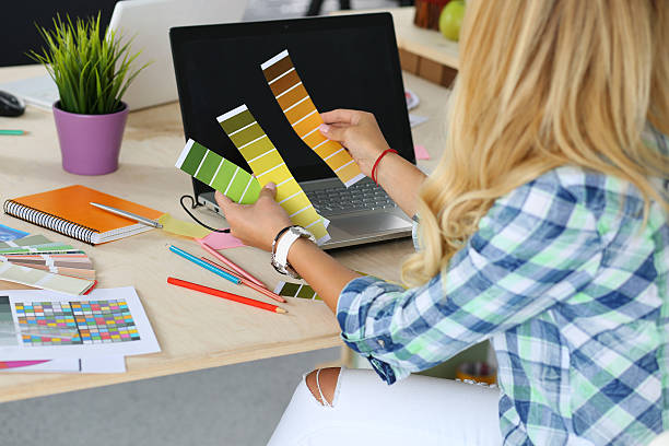 istock Hands of female designer in office working with colour samples 490639176