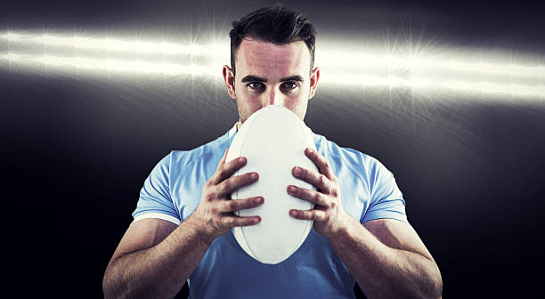 istock Composite image of rugby player looking at camera with ball 490640254