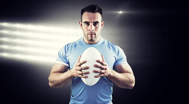 istock Composite image of rugby player looking at camera with ball 490640320