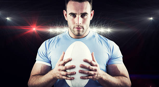 istock Composite image of rugby player looking at camera with ball 490640334