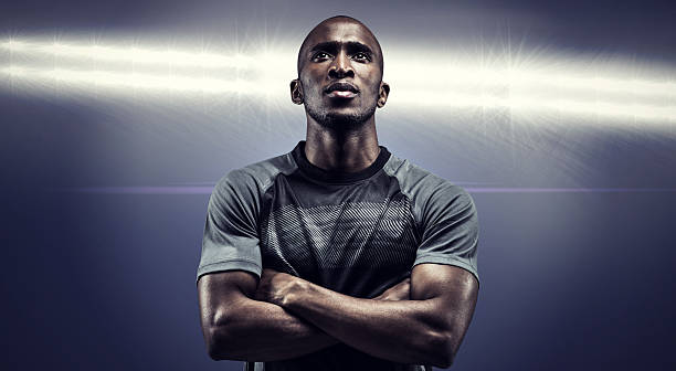 istock Composite image of thoughtful athlete standing with arms crossed 490640372