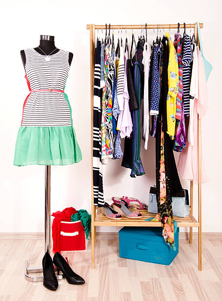 istock Dressing closet with colorful clothes arranged on hangers. 490640760