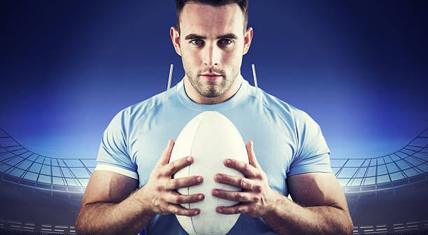 istock Composite image of rugby player looking at camera with ball 490641878
