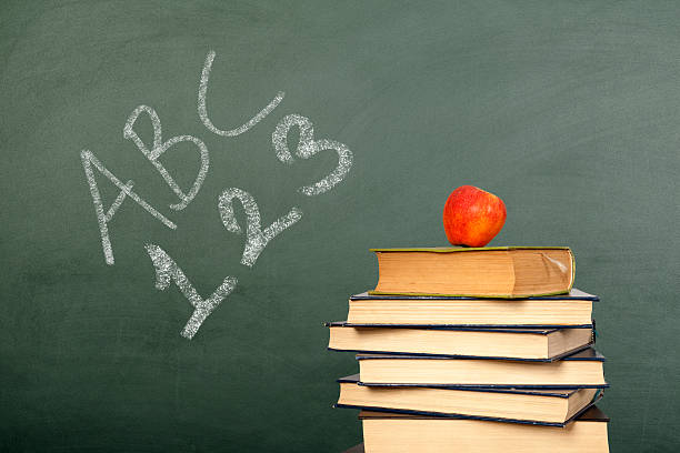 istock ABC 123 Writen with book on Chalkboard 490641984