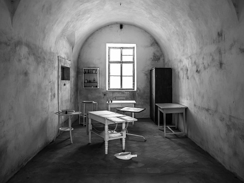 Vintage medical office in old abandoned hospital. Black and white image