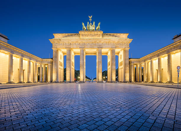 Brandenburg Gate in twilight at dawn, Berlin, Germany Panoramic view of famous Brandenburger Tor (Brandenburg Gate), one of the best-known landmarks and national symbols of Germany, in twilight during blue hour at dawn, Berlin, Germany. east berlin photos stock pictures, royalty-free photos & images