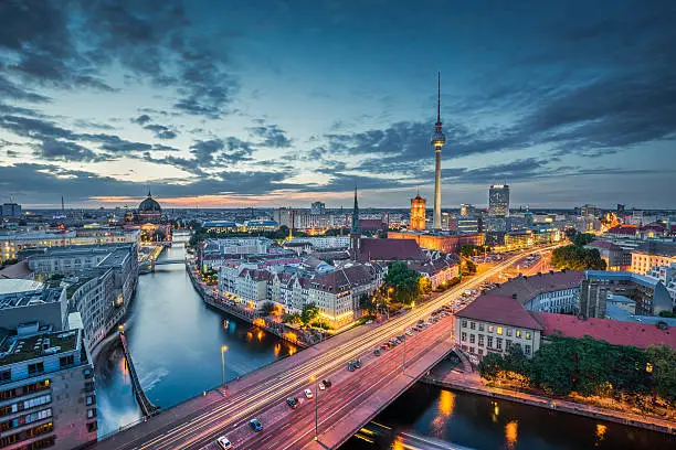 Aerial view of Berlin skyline with dramatic clouds in twilight during blue hour at dusk, Germany