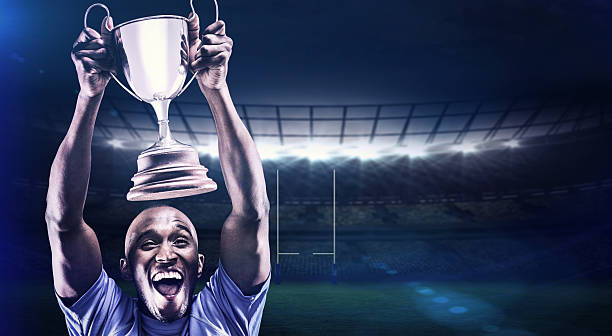 istock Composite image of happy athlete cheering while holding trophy 490642898