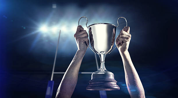 istock Composite image of successful rugby player holding trophy 490643158