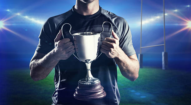 istock Composite image of victorious rugby player holding trophy 490643196