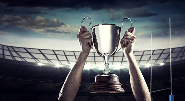 istock Composite image of successful rugby player holding trophy 490643578