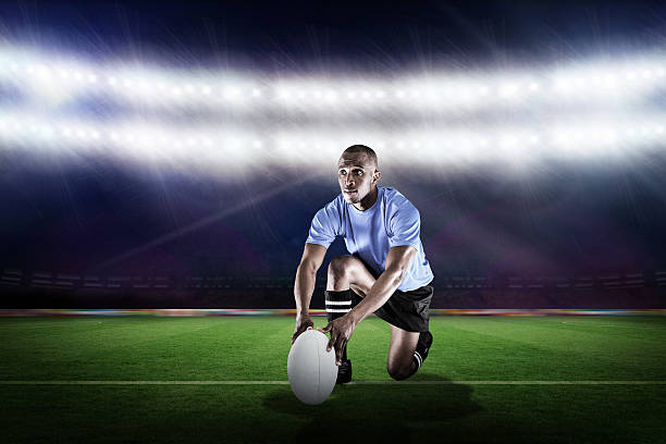 istock Composite image of rugby player holding ball while kneeling 490643960