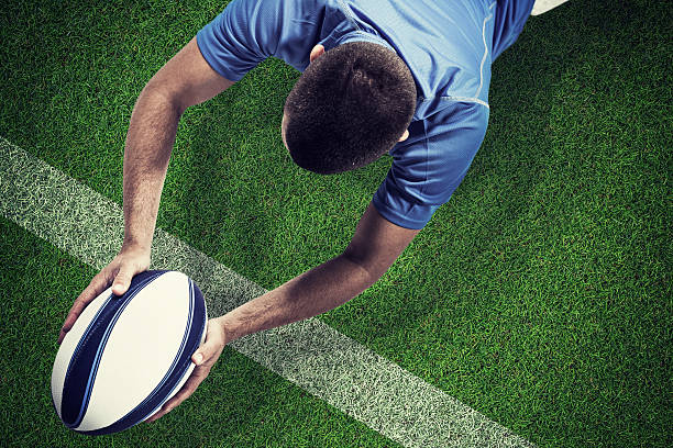 istock Composite image of rugby player lying in front with ball 490645344