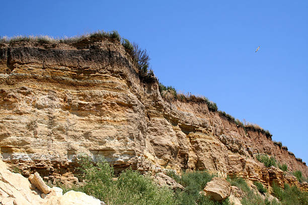 istock Sandy cliff above the sea and the sky. 490645534