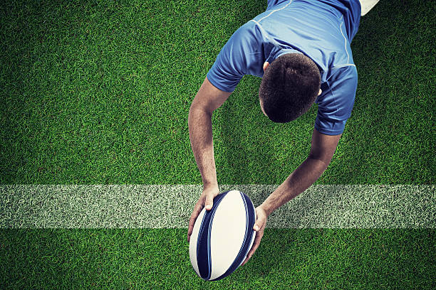 istock Composite image of rugby player lying in front with ball 490645596