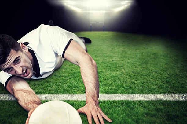 istock Composite image of man holding rugby ball while lying down 490646272