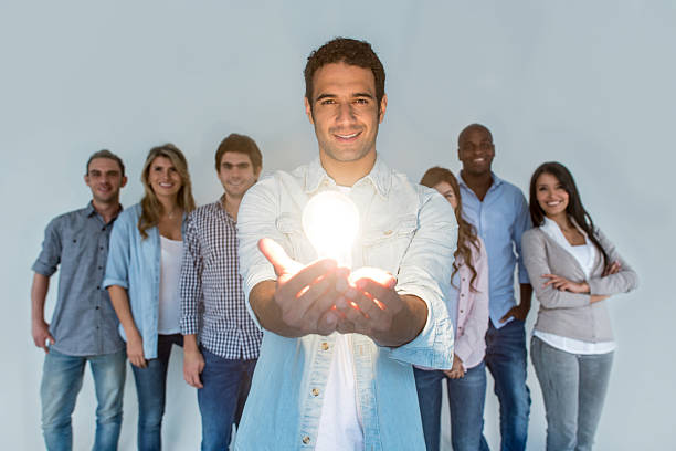 istock Casual business man holding a lit light bulb 490646780