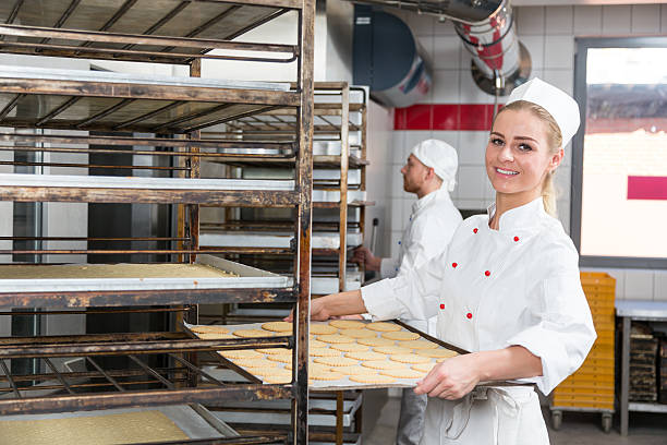 istock Baker presenting tray with pastry or dough at bakery 490647166
