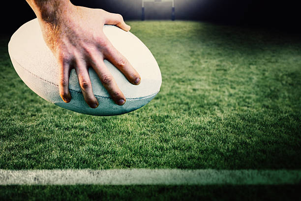istock Composite image of rugby player posing feet on the ball 490647820