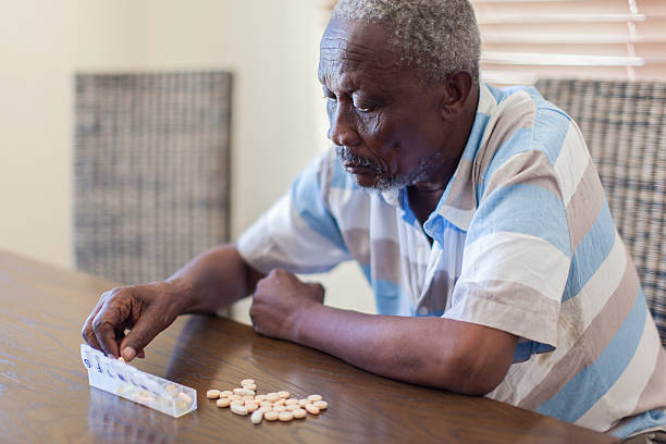 istock African senior taking his medication. 490652563