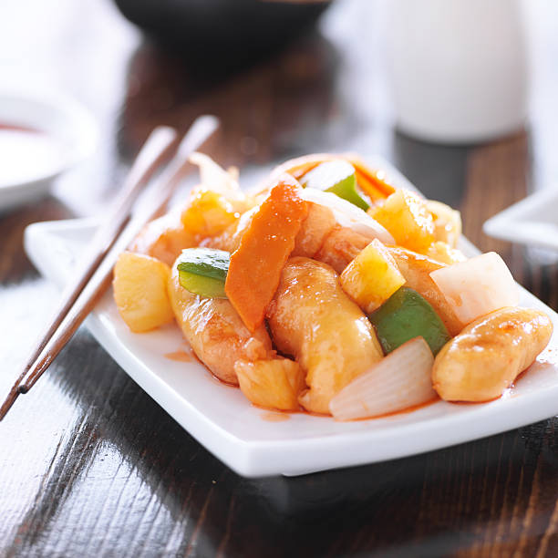 istock chinese sweet and sour chicken with chopsticks 490652989