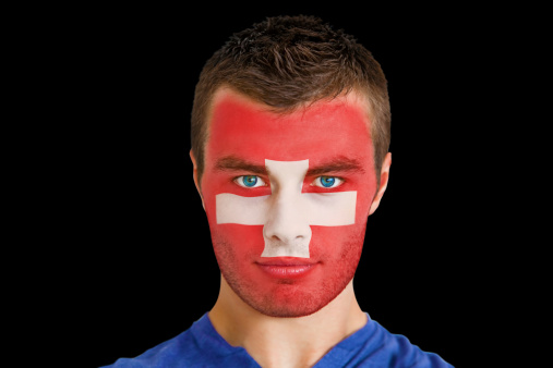 Serious young swiss fan with facepaint