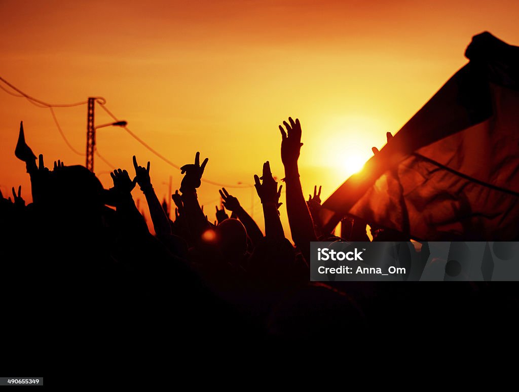 Revolution Revolution, people protest against government, man fighting for rights, silhouettes of hands up in the sky, threat of war Protest Stock Photo