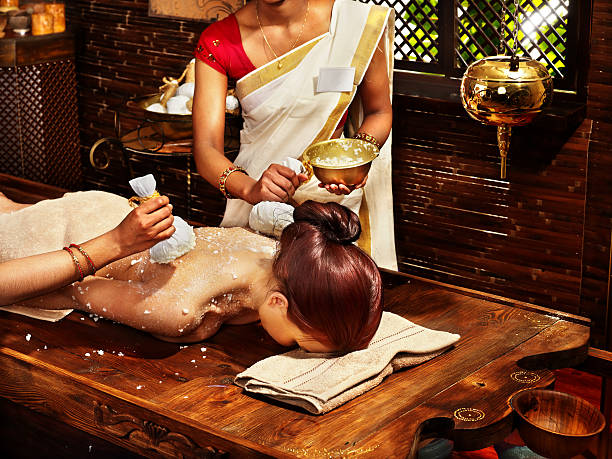 istock Woman having massage with pouch of rice. 490655409