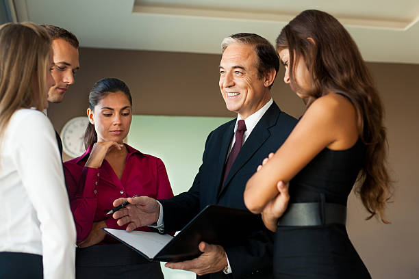 istock Mature business man talking to his team 490655653