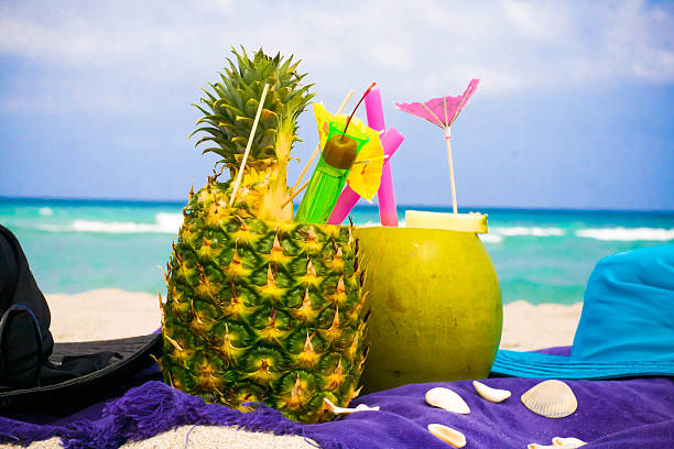 Tropical cocktails served in a coconut and a pineapple.
