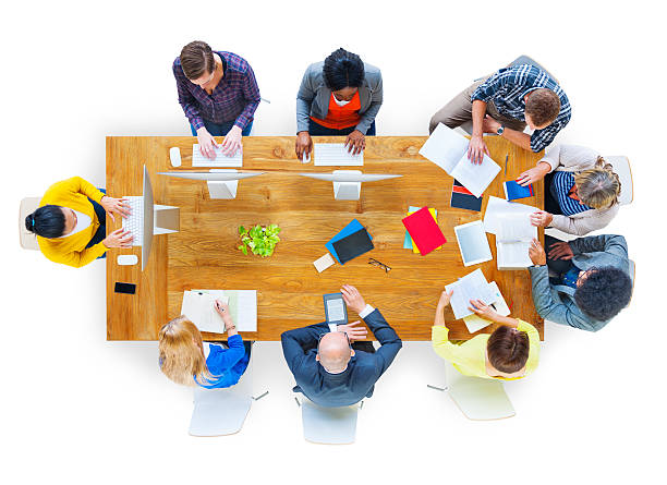 istock Overhead shot of group seated around table 490656249