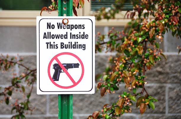 No Guns Sign Presumed deterrent for armed criminals. gun control photos stock pictures, royalty-free photos & images
