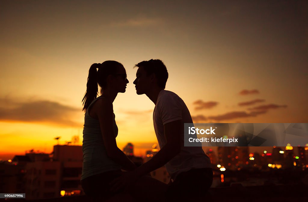 Love in the city Couple kissing at night in the city Teenager Stock Photo