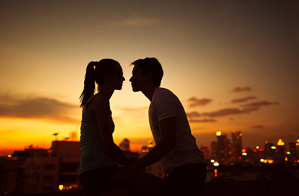Love in the city Couple kissing at night in the city teen romance stock pictures, royalty-free photos & images