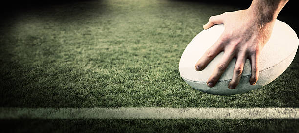 istock Composite image of rugby player posing feet on the ball 490658082