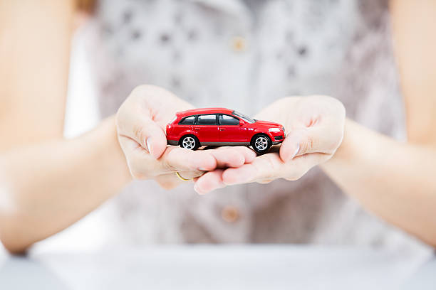 istock Woman hand with holding red car 490658107