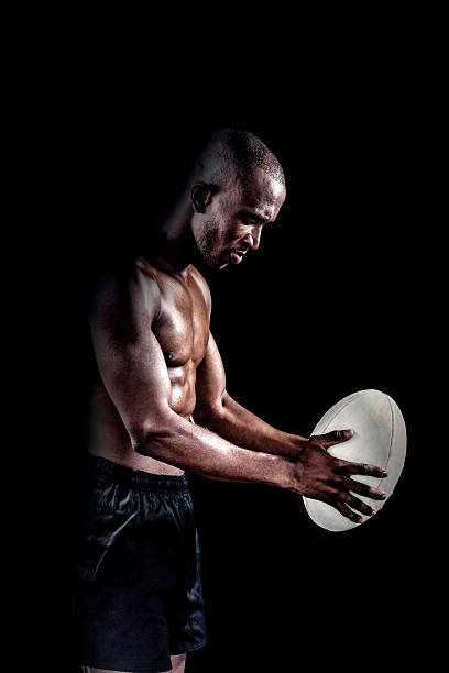 istock Shirtless athlete playing with rugby ball 490658438