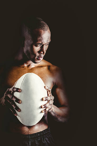 istock Concentrated shirtless athlete with rugby ball 490658496