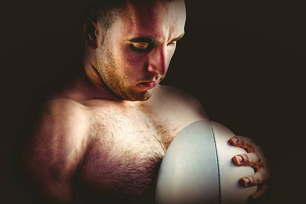 istock Shirtless rugby player holding ball 490658702