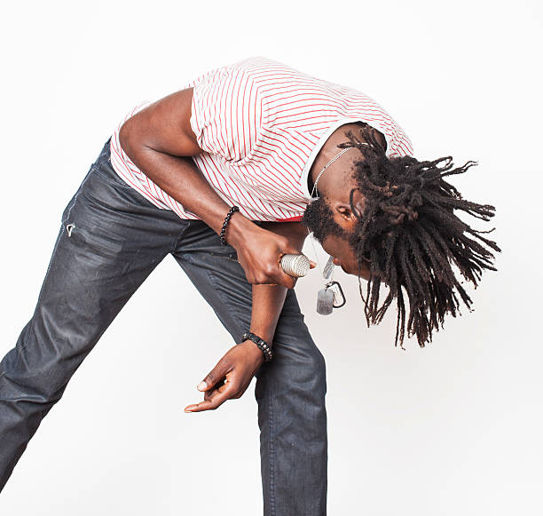 istock young handsome african american boy singing emotional with microphone isolated 490659672