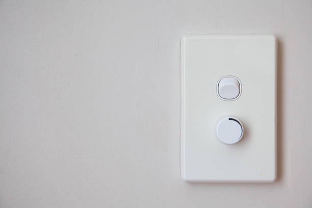 Light Switch and Dimmer Close up view of a light switch with dimmer. Horizontal shot with copy space. No people. dimmer switch photos stock pictures, royalty-free photos & images