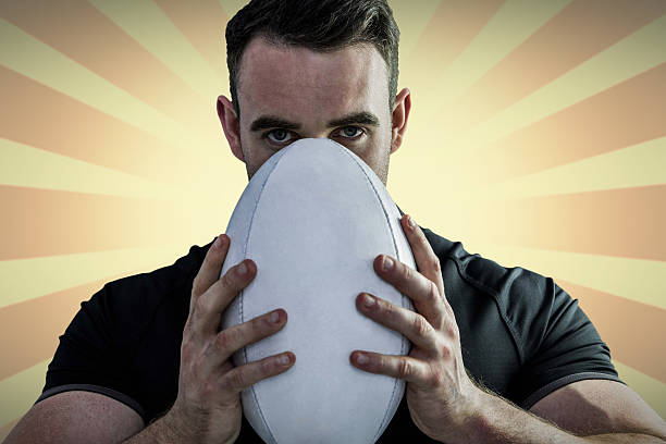 istock Composite image of tough rugby player holding ball 490663256