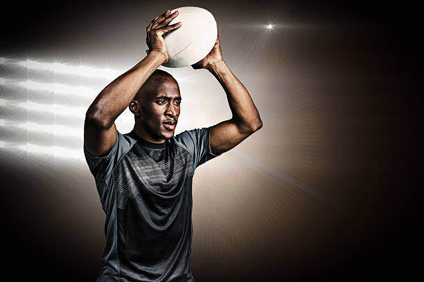 istock Composite image of confident sportsman throwing rugby ball 490664492