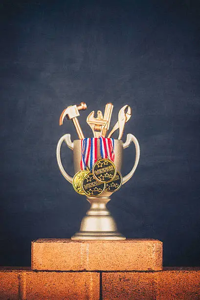 Photo of Trophy with winner medals and gold tools on gold bricks